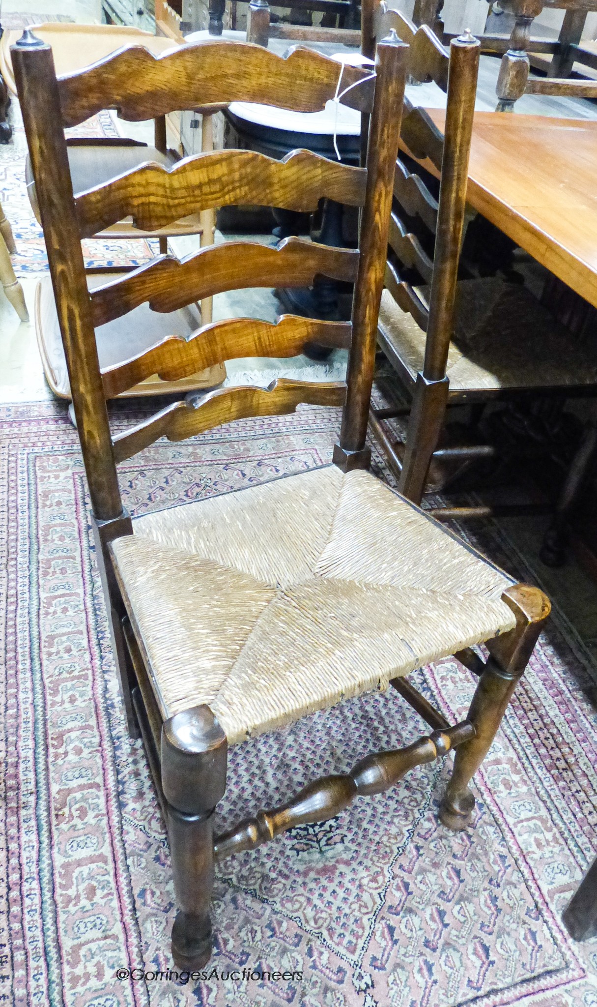 A set of four 18th century style ash rush seat ladderback dining chairs